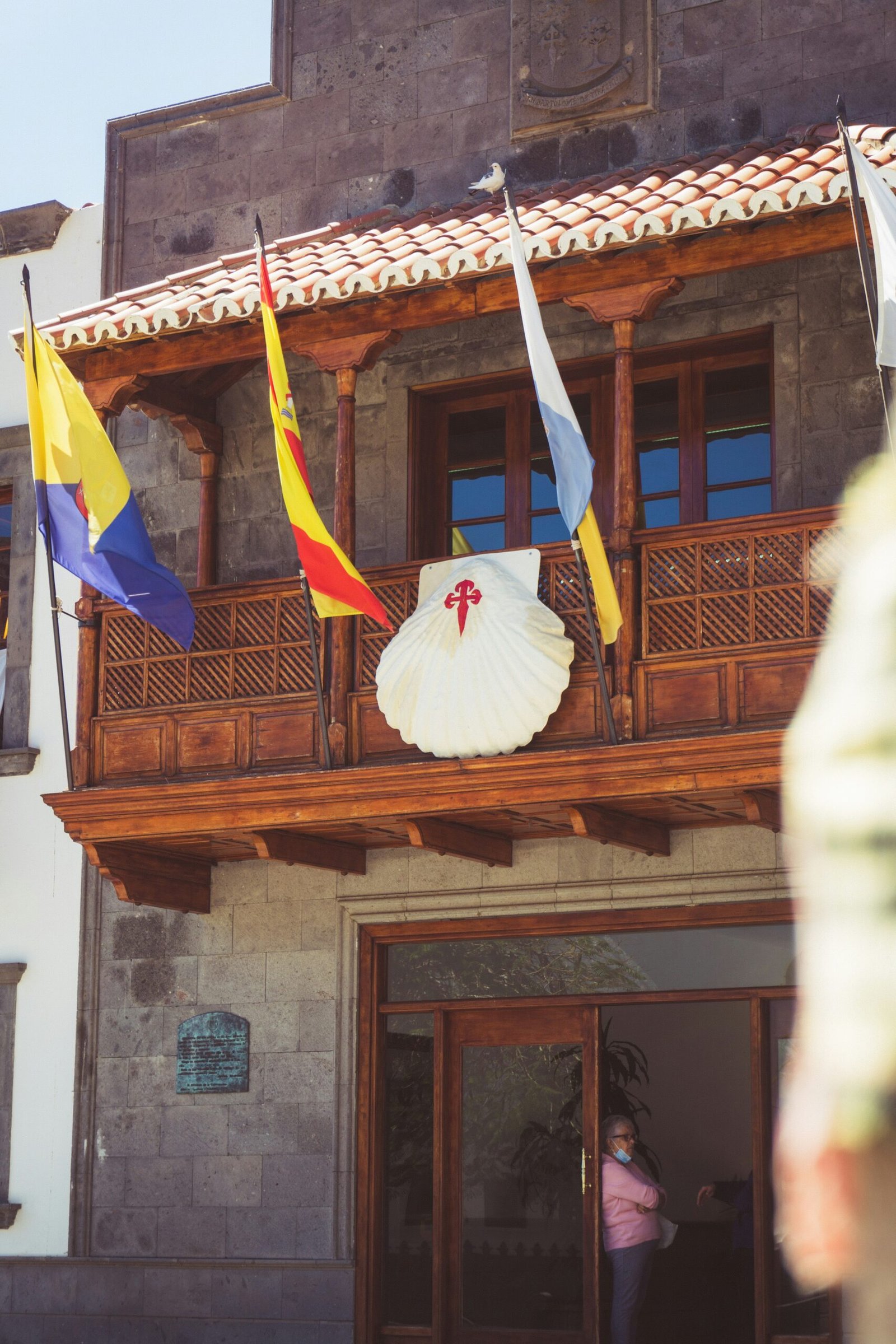 a building with flags on the roof